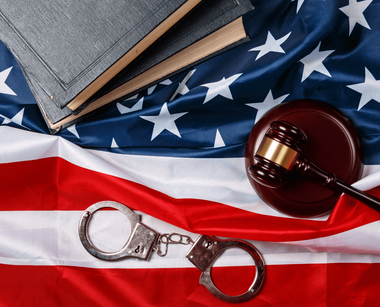 Wooden Gavel and handcuffs on USA flag